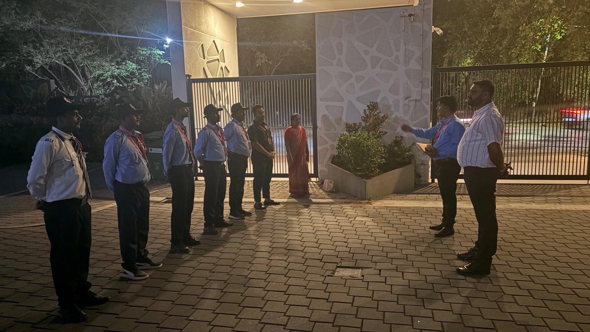 Assured Security Services supervisor speaking with a guard during a site round