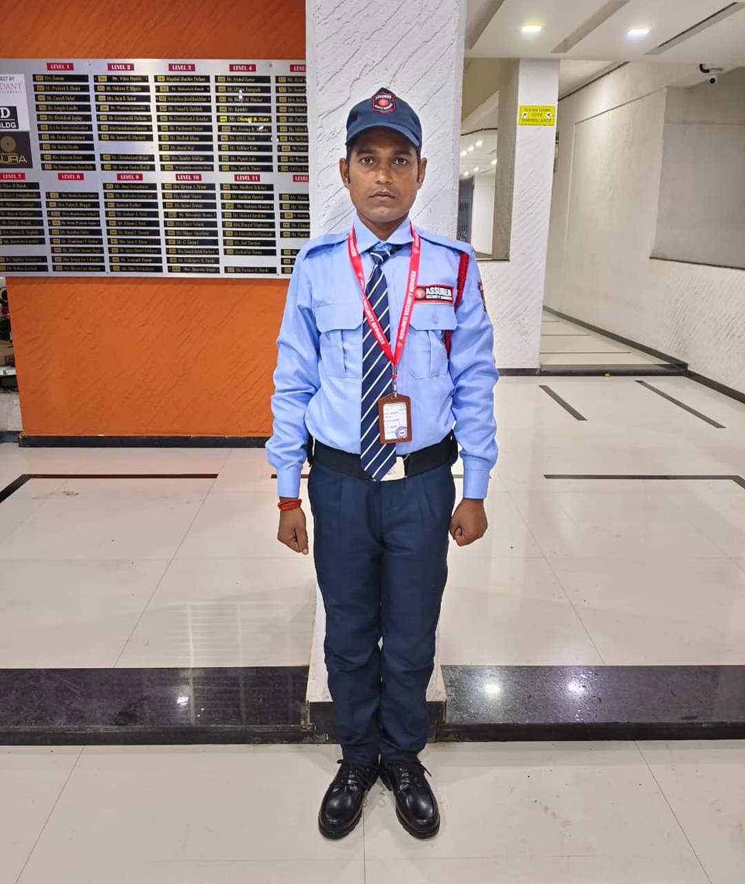 Assured Security Services guard standing ready at a client property